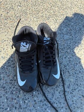 Nike Black and White Athletic Cleats with Prominent Swoosh